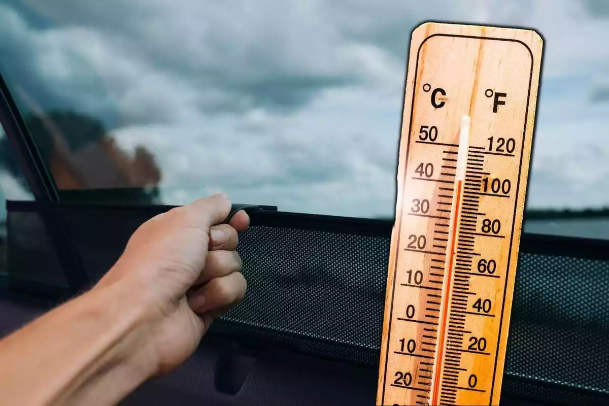 Mà pujant cortineta solar de cotxe i al costat un termòmetre indicant altes temperatures